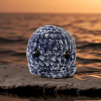 Handmade crochet mini octopus plushie in soft blue, perfect for gifts and adding charm to any room.